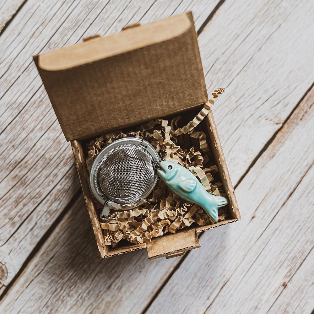 tea infuser with ceramic blue fish hanging from the chain
