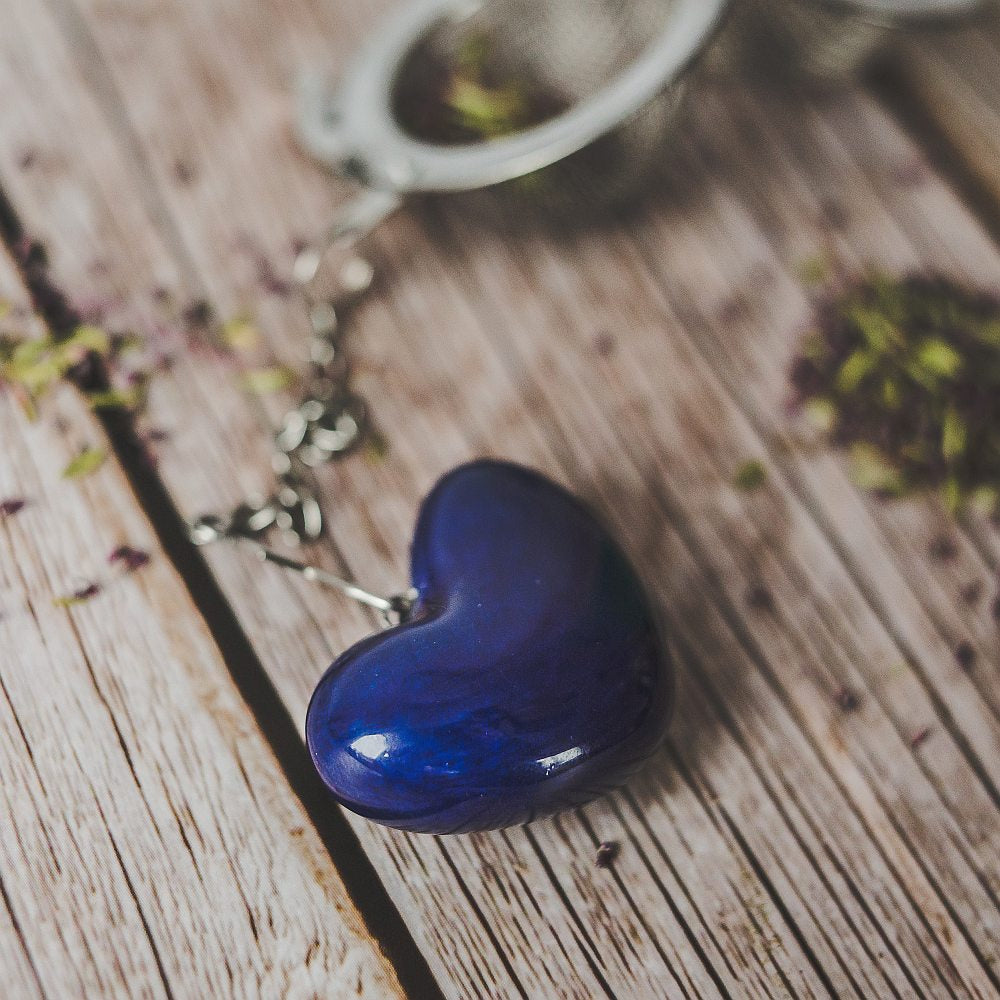 Tea infuser with ceramic blue heart hanging from the chain.