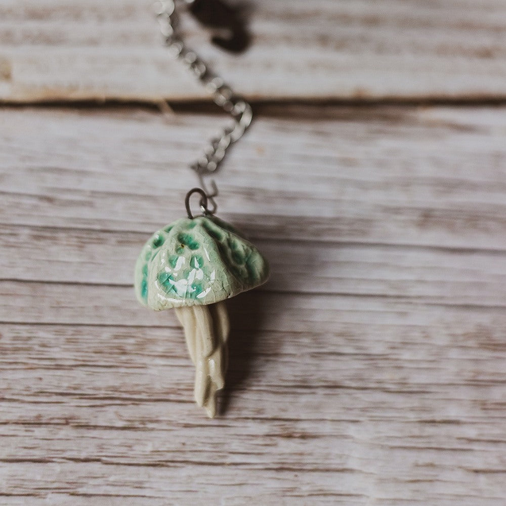 tea infuser with ceramic blue jellyfish hanging from the chain