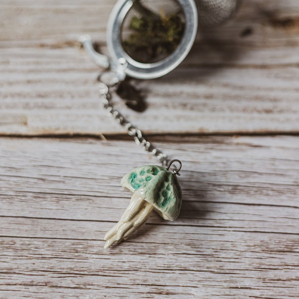 tea infuser with ceramic blue jellyfish hanging from the chain