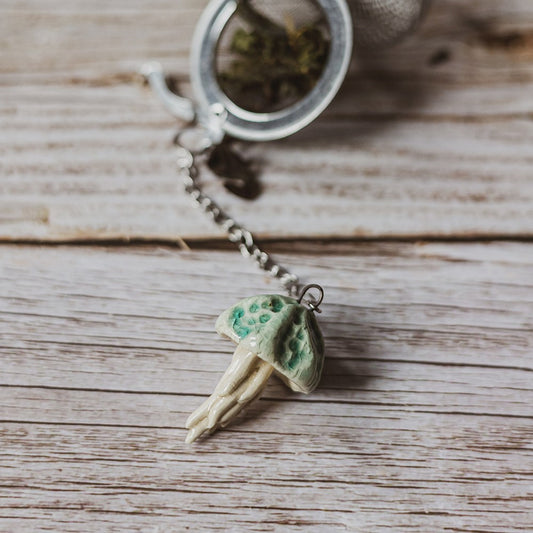 tea infuser with ceramic blue jellyfish hanging from the chain