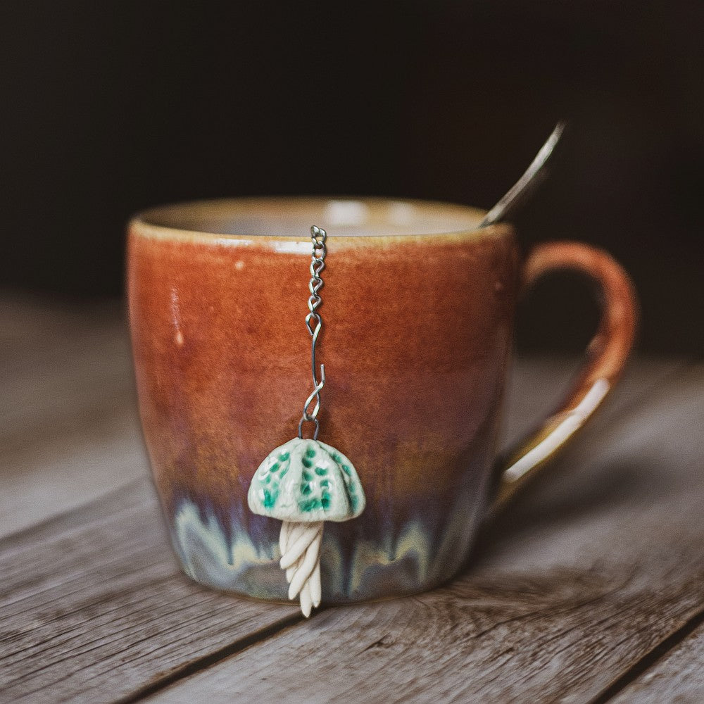 tea infuser with ceramic blue jellyfish hanging from the chain