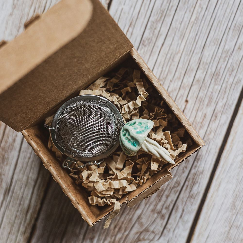 tea infuser with ceramic blue jellyfish hanging from the chain
