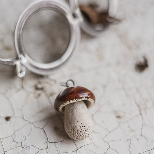 tea infuser with ceramic boletus mushroom hanging from the chain