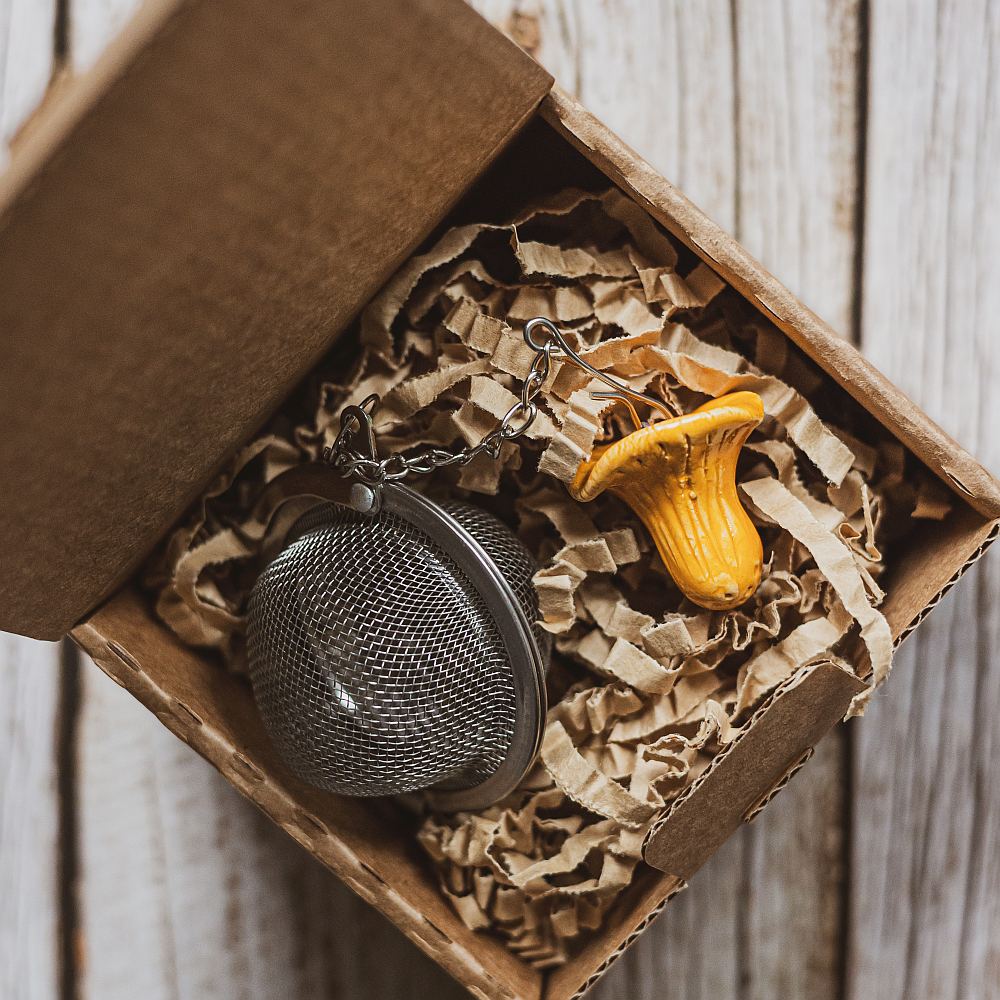 tea infuser with ceramic chanterelle mushroom hanging from the chain