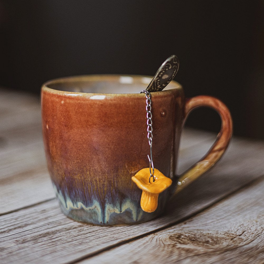 tea infuser with ceramic chanterelle mushroom hanging from the chain