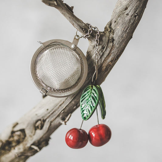Tea infuser with ceramic cherries hanging from the chain.