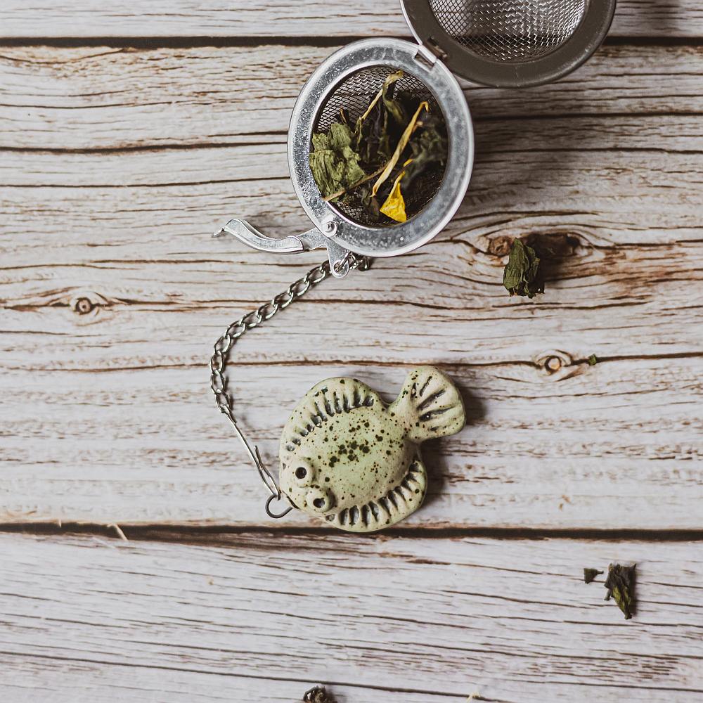 tea infuser with ceramic green flatfish hanging from the chain