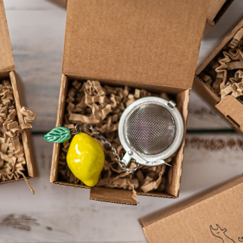 tea infuser with ceramic lemon hanging from the chain
