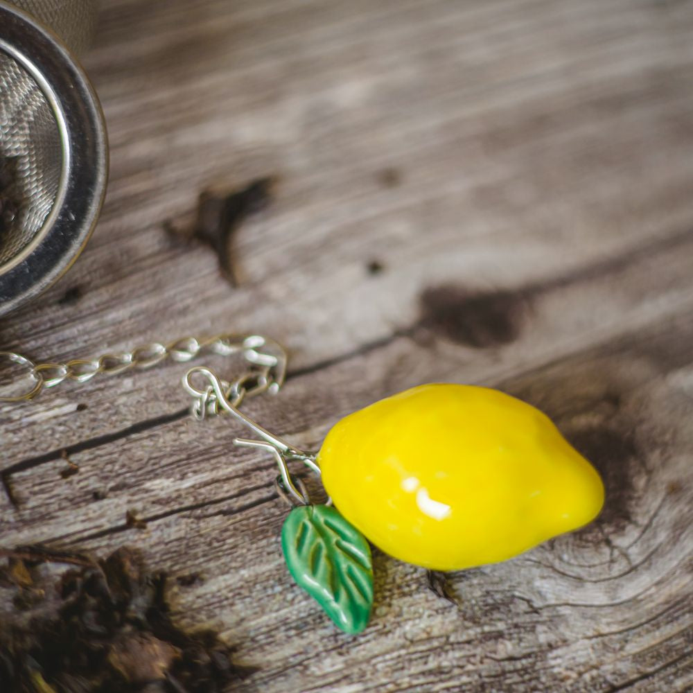tea infuser with ceramic lemon hanging from the chain