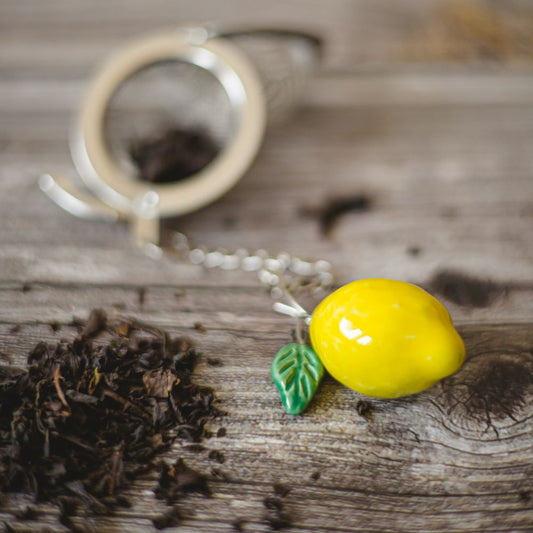 tea infuser with ceramic lemon hanging from the chain