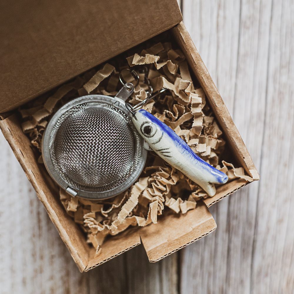 tea infuser with ceramic long fish hanging from the chain