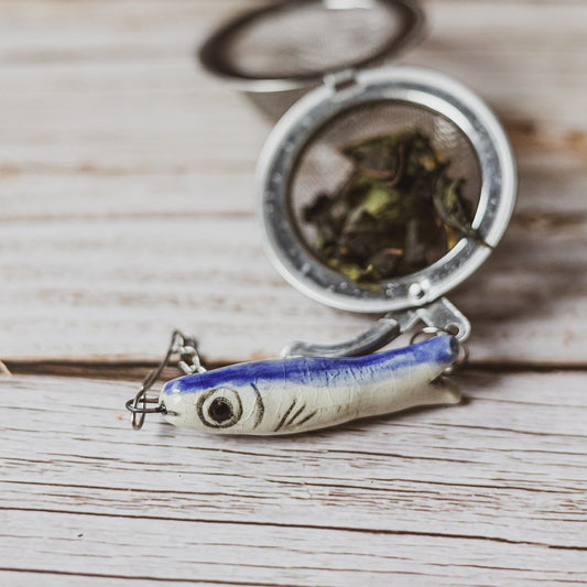 tea infuser with ceramic long fish hanging from the chain