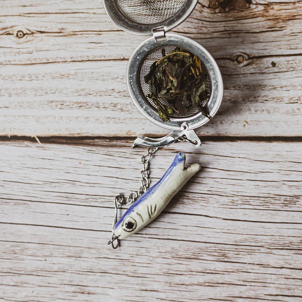 tea infuser with ceramic long fish hanging from the chain