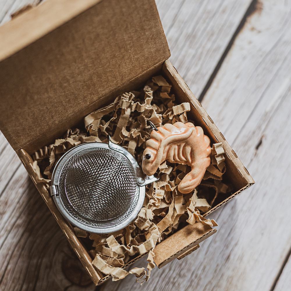 tea infuser with ceramic pink shrimp hanging from the chain