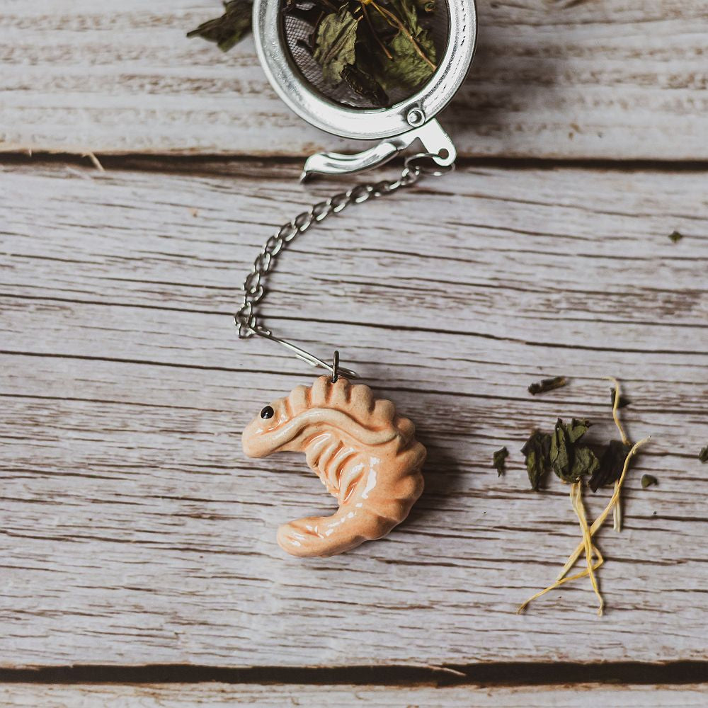 tea infuser with ceramic pink shrimp hanging from the chain