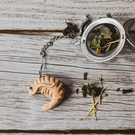 tea infuser with ceramic pink shrimp hanging from the chain
