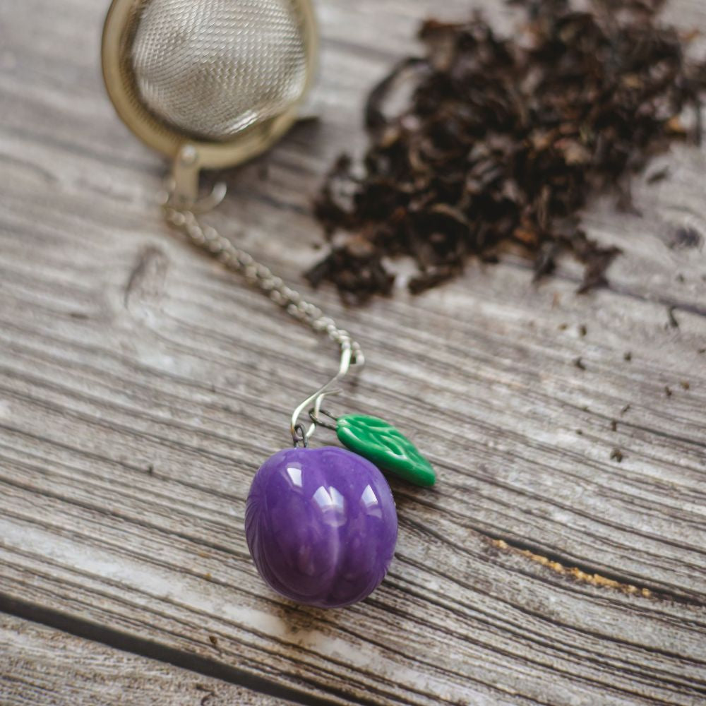 tea infuser with ceramic blue plum hanging from the chain