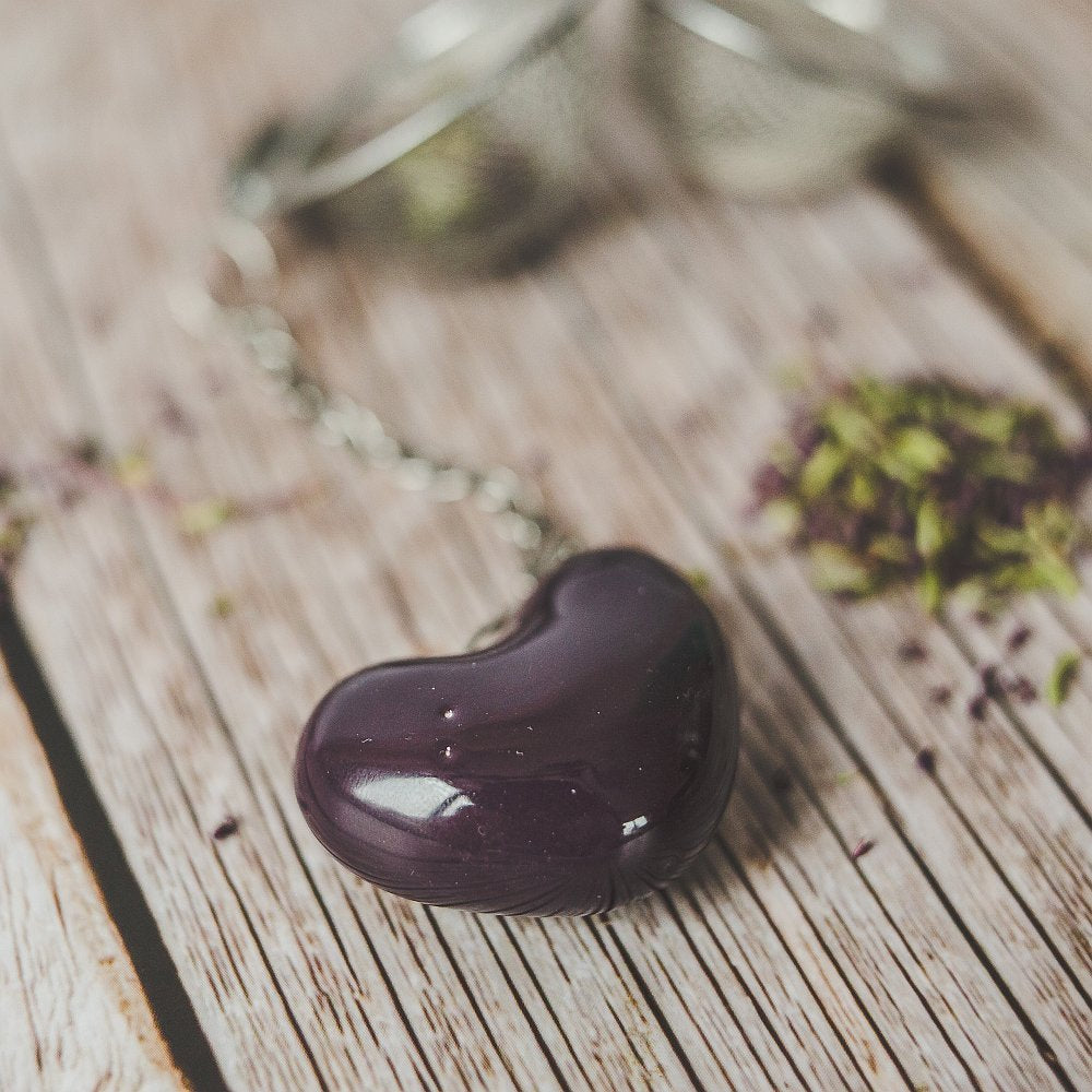 Tea infuser with ceramic purple heart hanging from the chain.