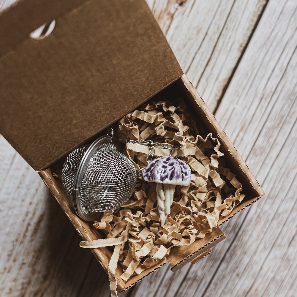 tea infuser with ceramic purple jellyfish hanging from the chain