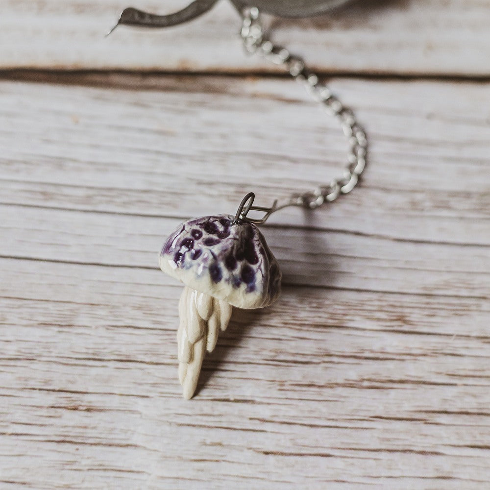 tea infuser with ceramic purple jellyfish hanging from the chain