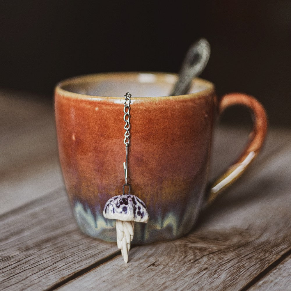 tea infuser with ceramic purple jellyfish hanging from the chain