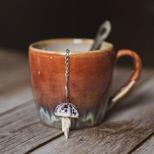 tea infuser with ceramic purple jellyfish hanging from the chain