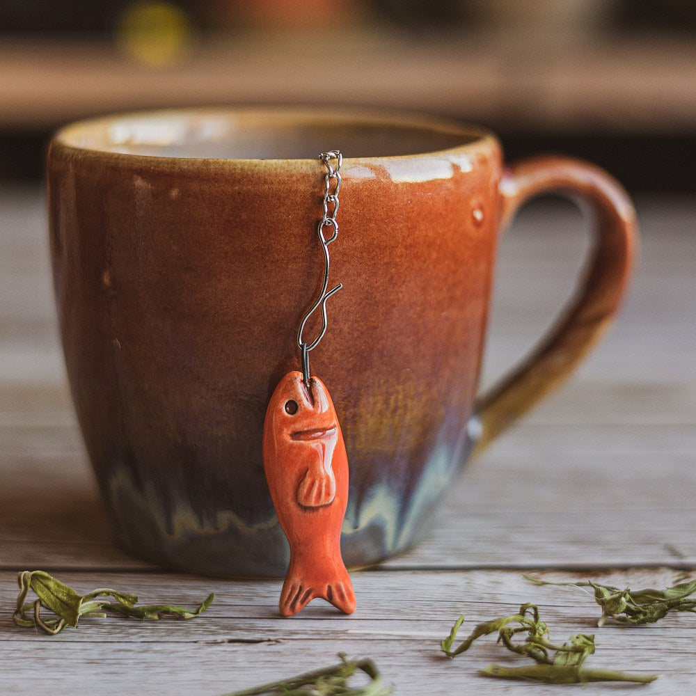 tea infuser with ceramic red fish hanging from the chain