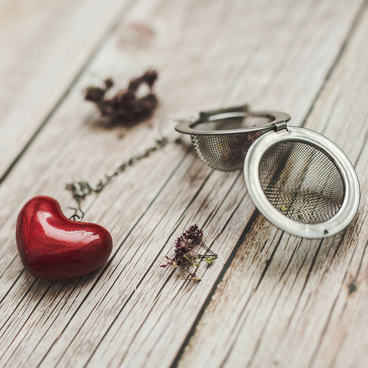 Tea infuser with ceramic red heart hanging from the chain.