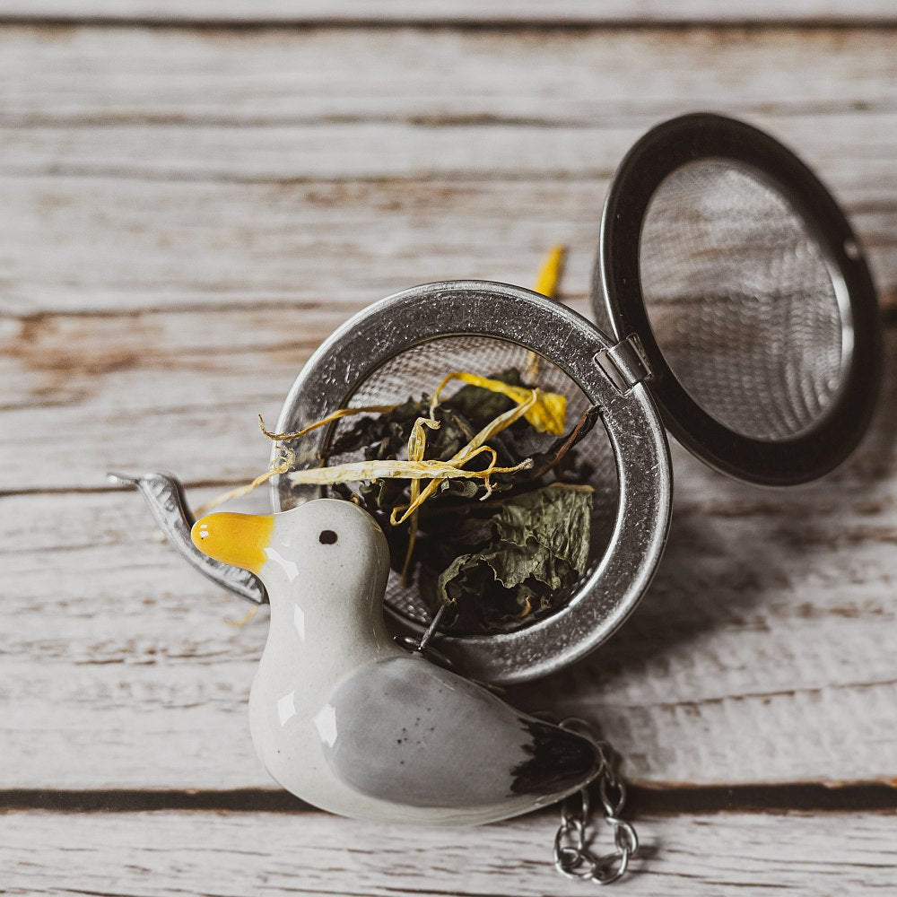 tea infuser with ceramic seagull hanging from the chain