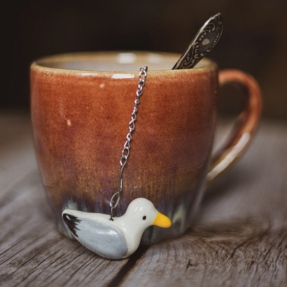 tea infuser with ceramic seagull hanging from the chain
