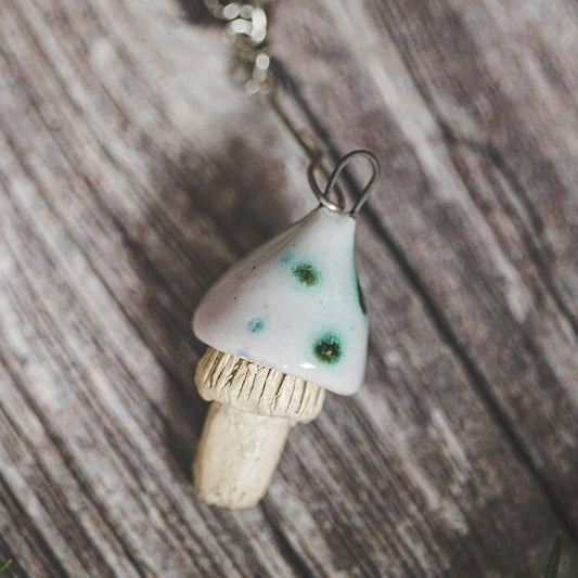 Tea infuser with ceramic swamp mushroom hanging from the chain.