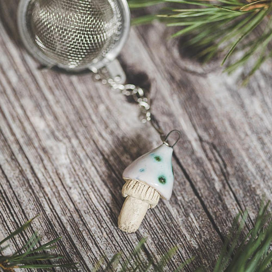 Tea infuser with ceramic swamp mushroom hanging from the chain.