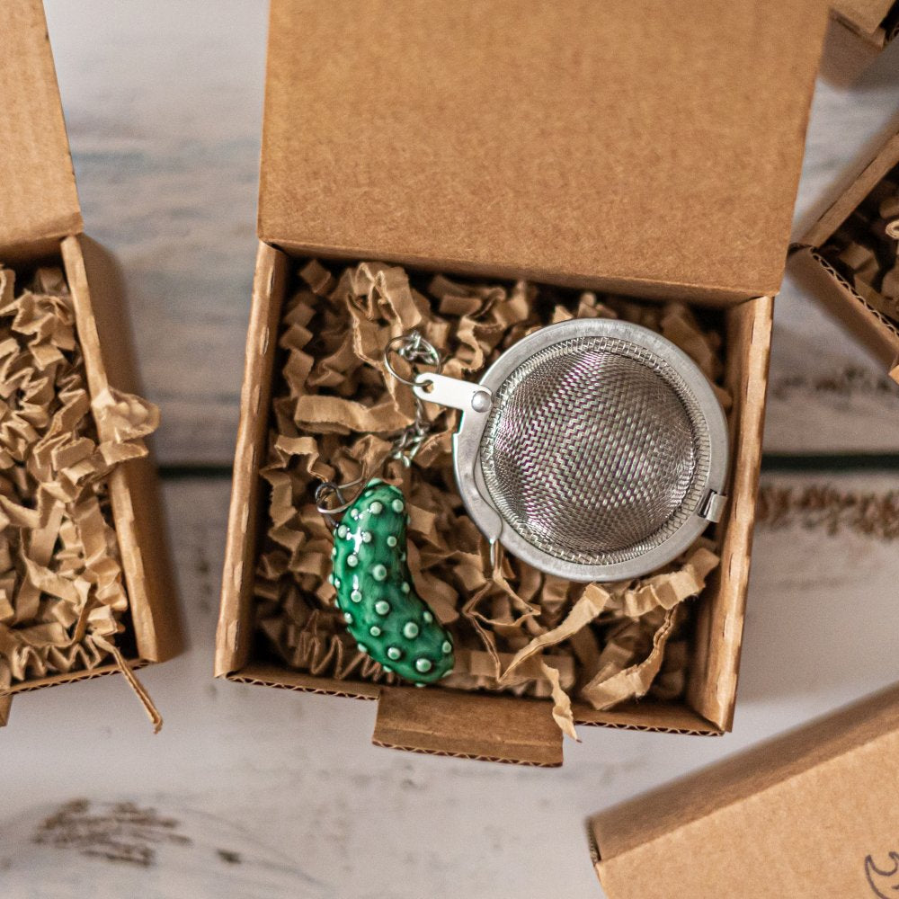 tea infuser with ceramic cucumber hanging from the chain