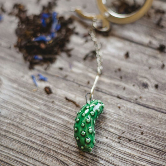 tea infuser with ceramic cucumber hanging from the chain