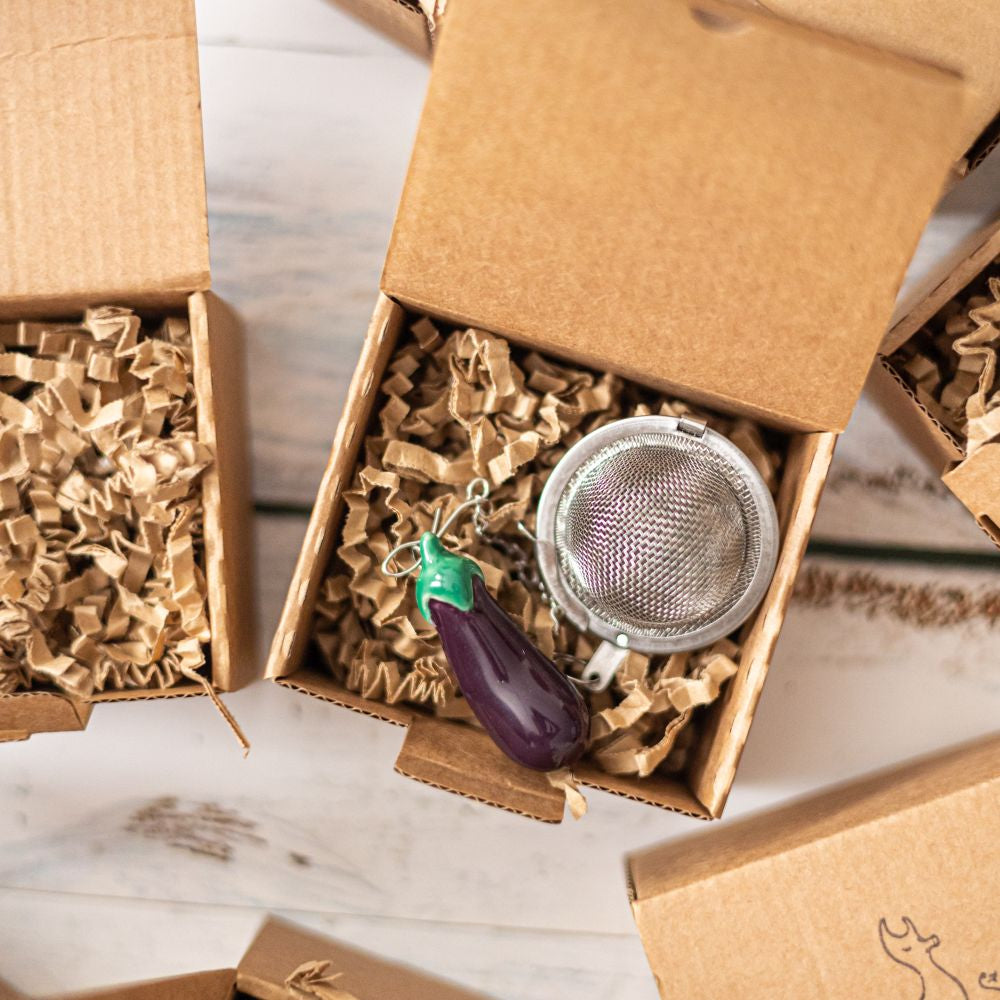 tea infuser with ceramic purple eggplant hanging from the chain