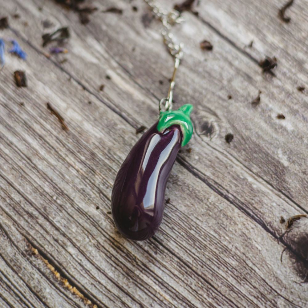 tea infuser with ceramic purple eggplant hanging from the chain