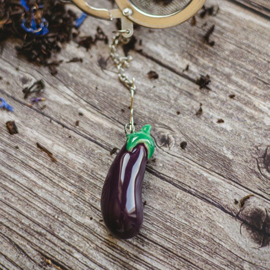tea infuser with ceramic purple eggplant hanging from the chain