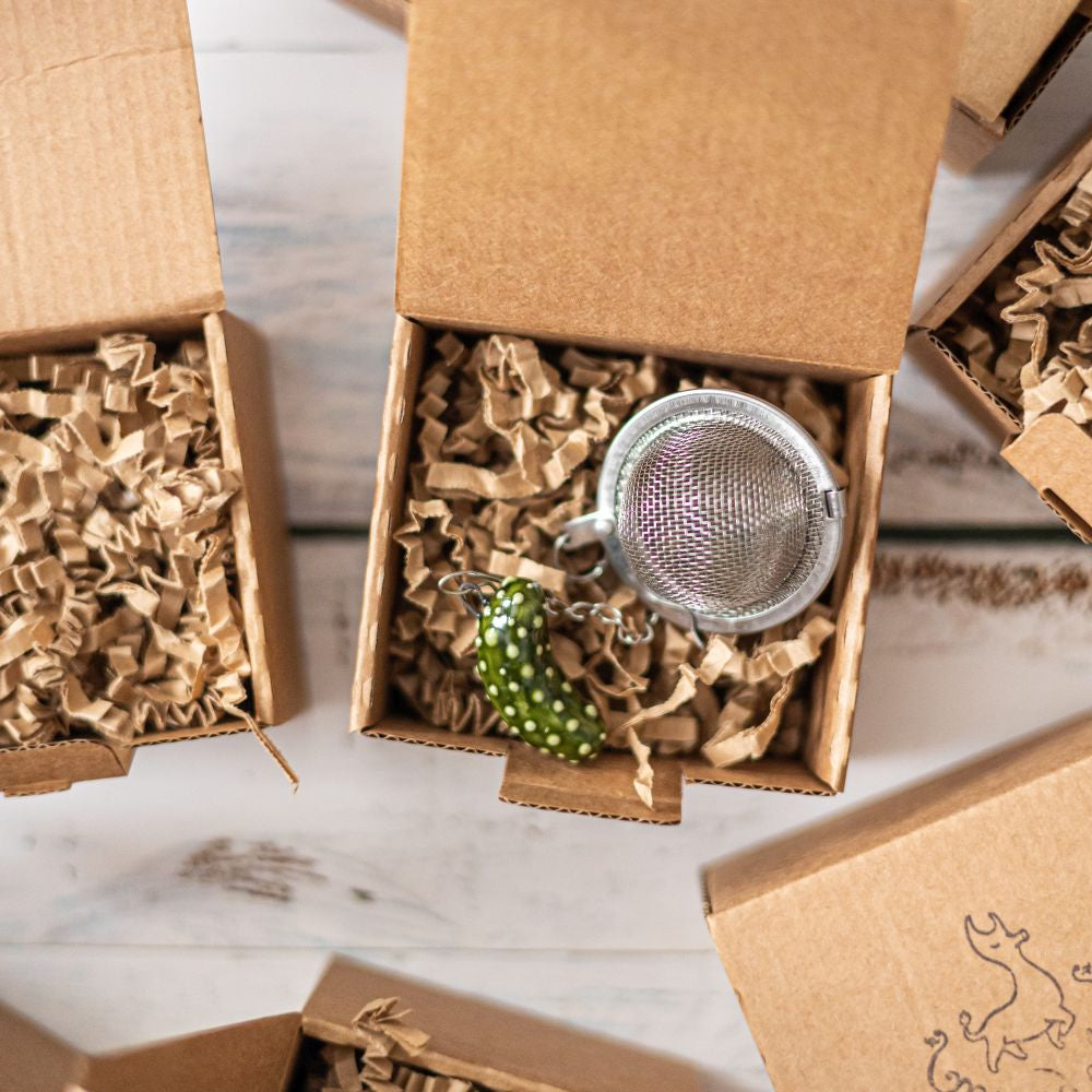 tea infuser with ceramic pickle hanging from the chain