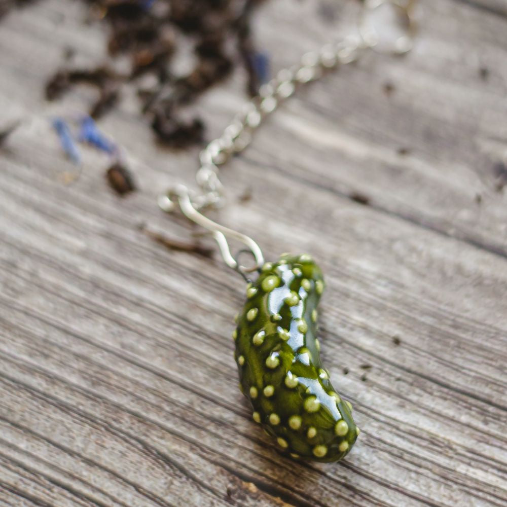 tea infuser with ceramic pickle hanging from the chain