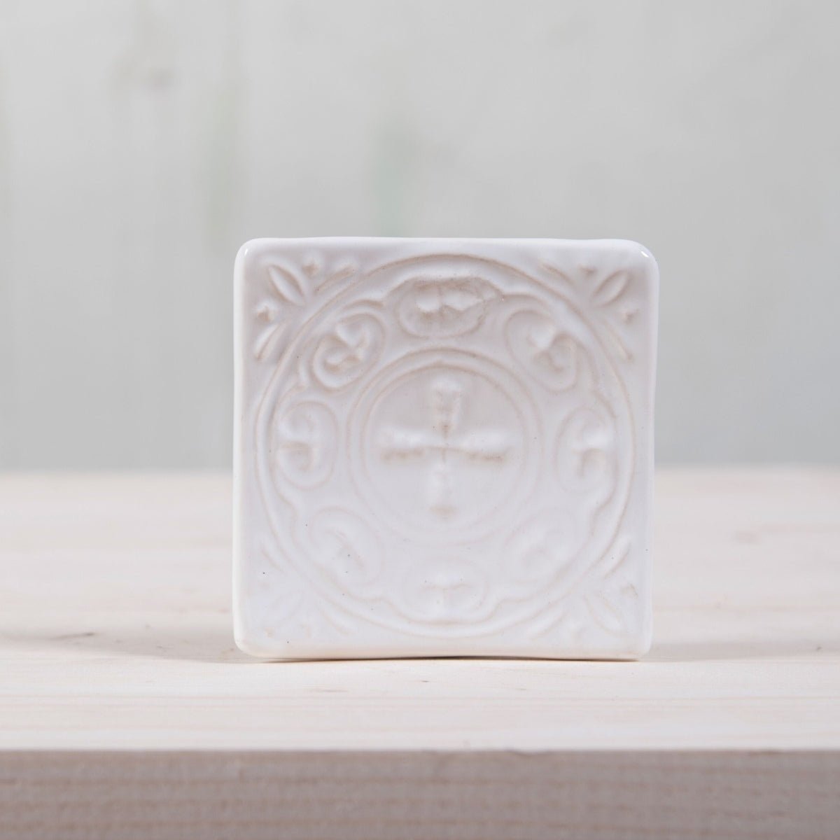 Handmade ceramic square soap dish. Crafted from white clay and finished with a glossy white glaze. Designed with drainage holes, a concave shape, and four little feet.